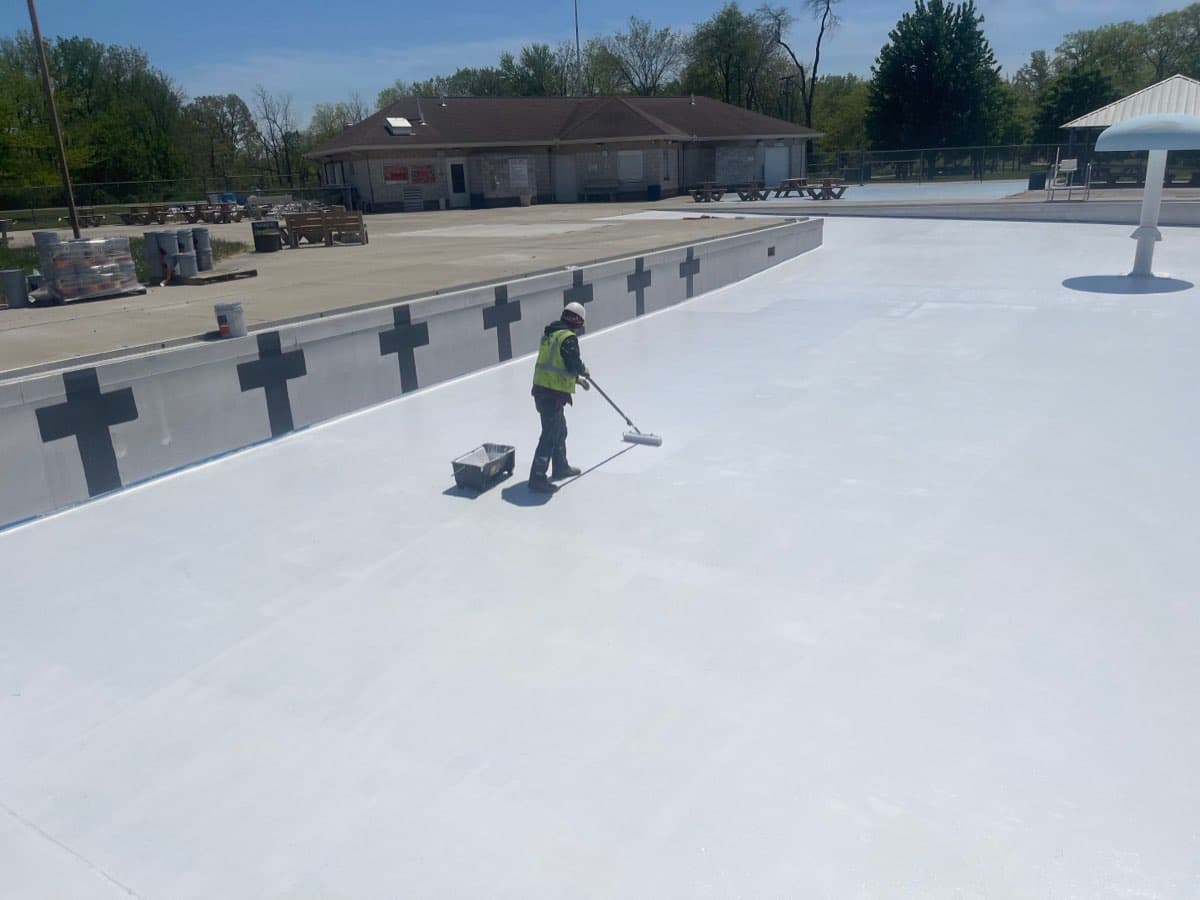 Large commercial pool coating application in progress