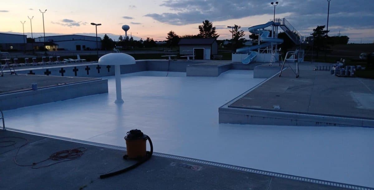 Wide view of commercial pool complex after painting by MPC