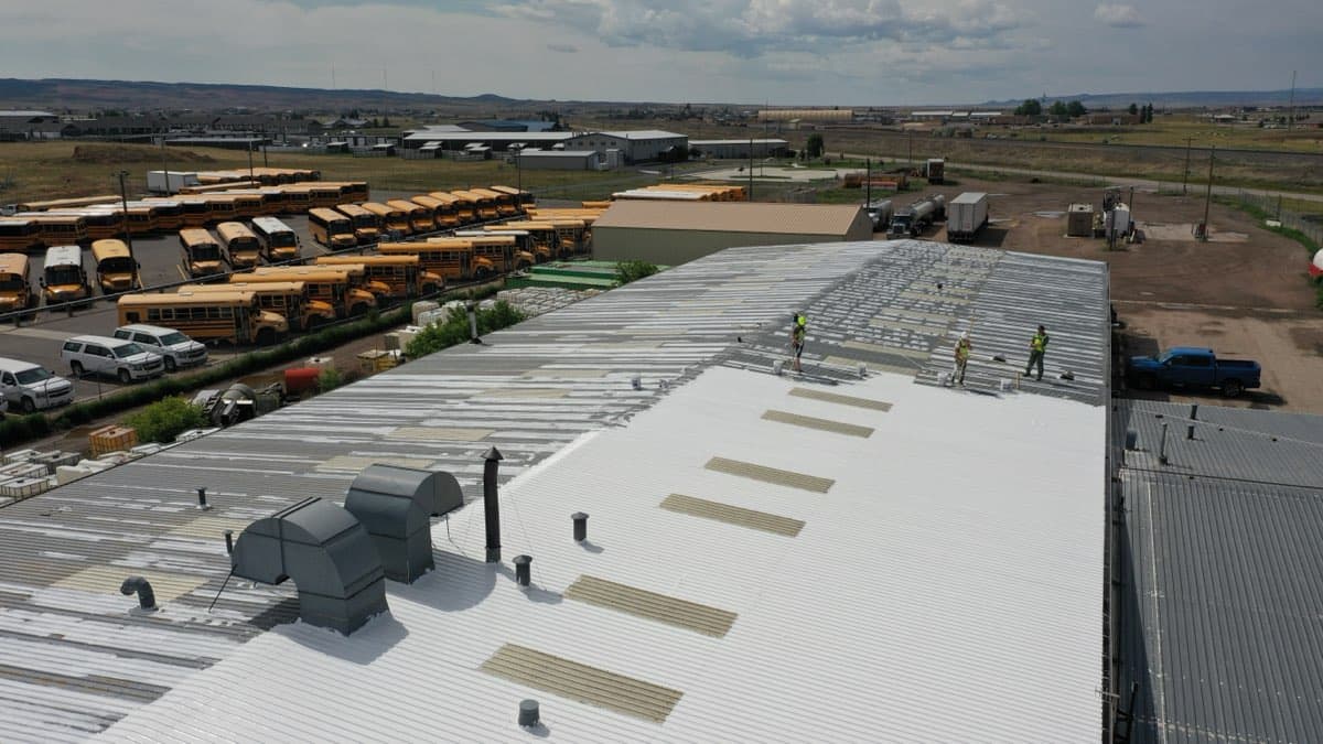 Aerial view of large commercial roof coating project by MPC