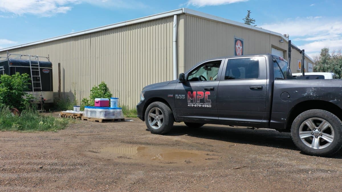 Drone shot of commercial roof coating in progress