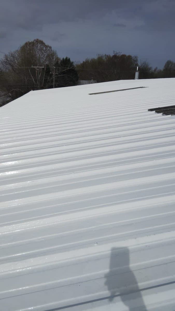 Roof coating application in progress