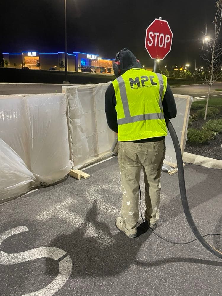 MPC crew sandblasting at commercial site at night