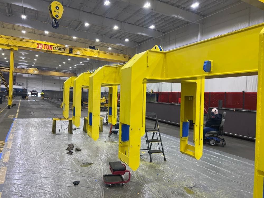 Industrial crane frames painted after sandblasting in manufacturing facility