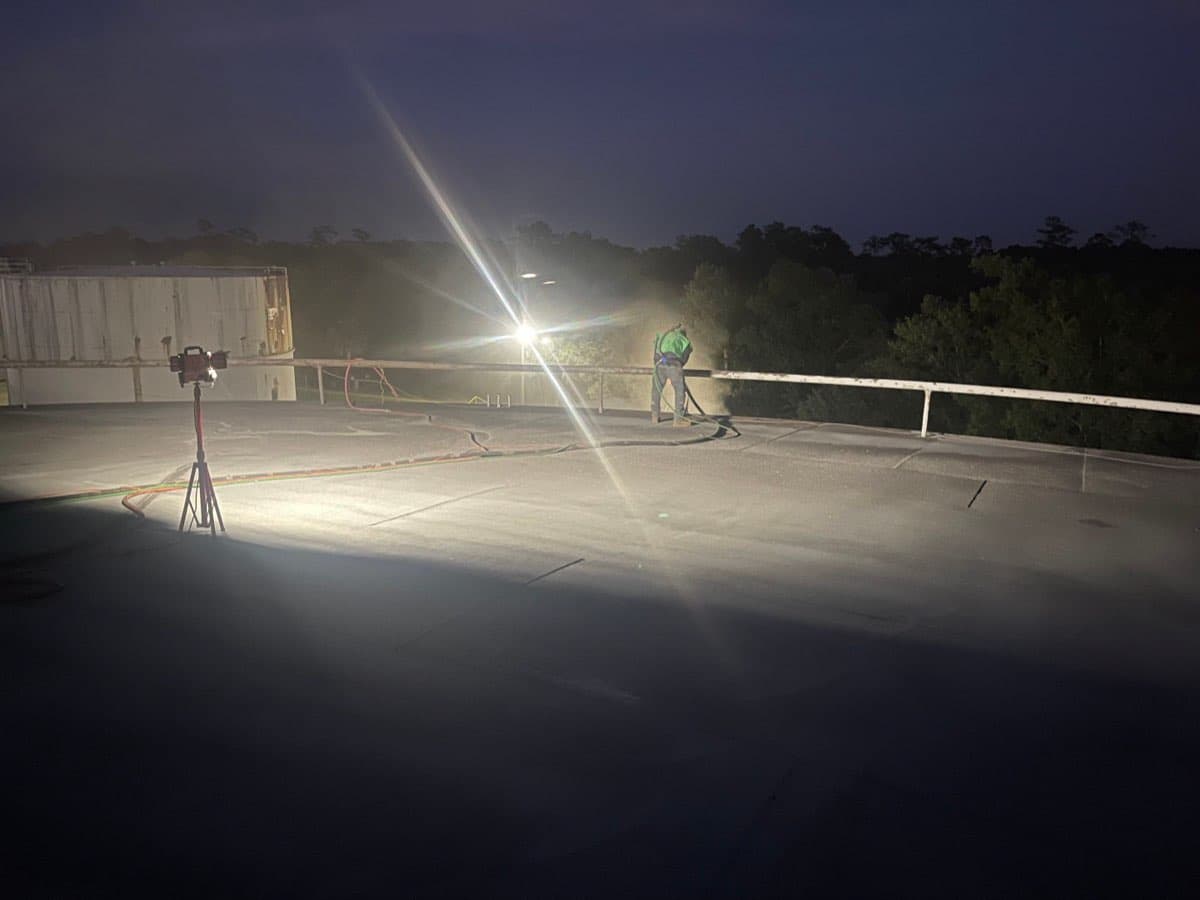 Night sandblasting operation on top of large storage tank