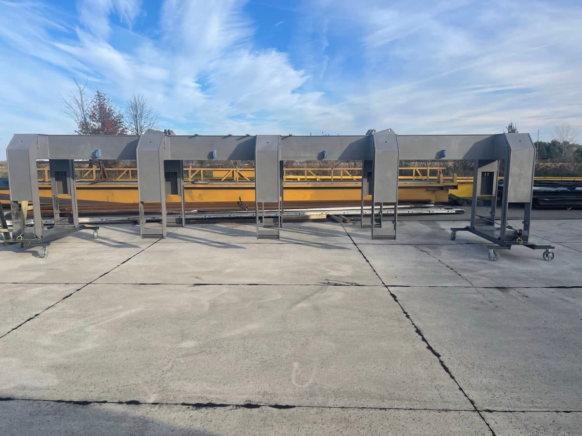 Row of large steel fabrication pieces after sandblasting