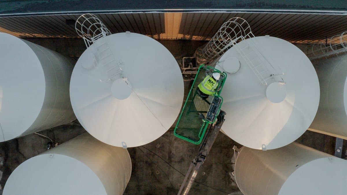 Aerial drone shot of agricultural storage tanks freshly painted