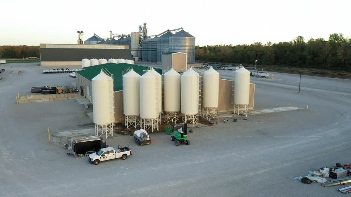 Drone view of agricultural silos being painted by MPC — large-scale project
