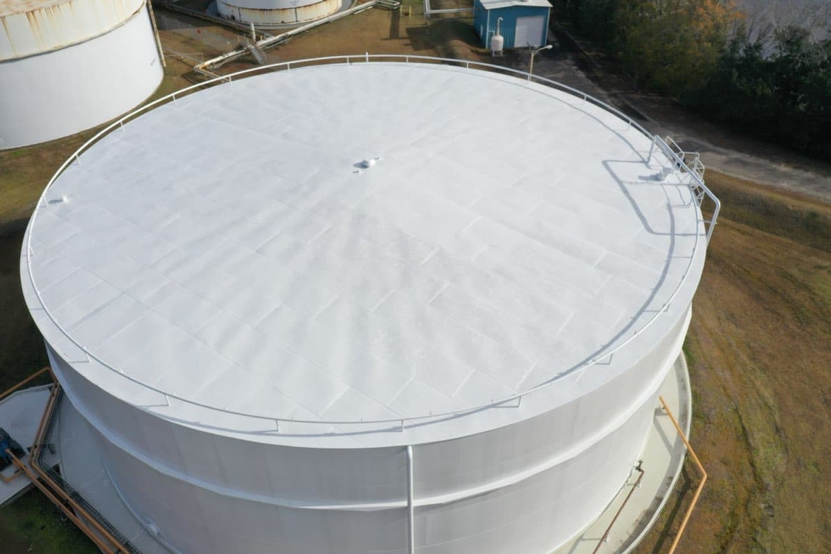 Aerial drone view of large agricultural tank freshly painted white
