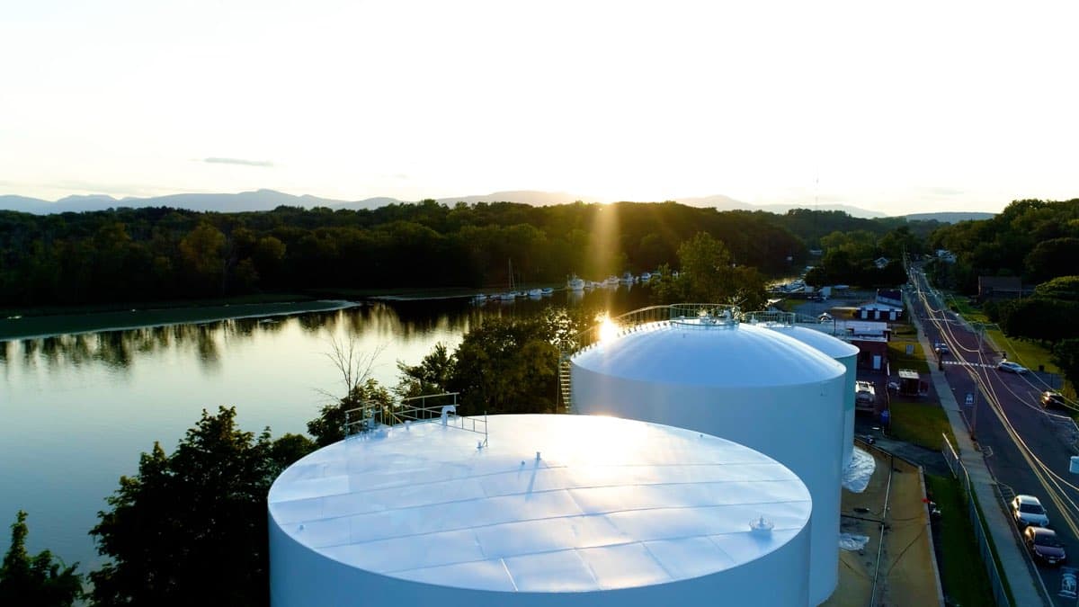 Drone aerial of freshly painted industrial storage tanks by Markley's Precision