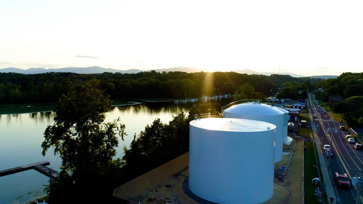 Aerial drone view of large fuel storage tanks painted by Markley's Precision Company at sunset